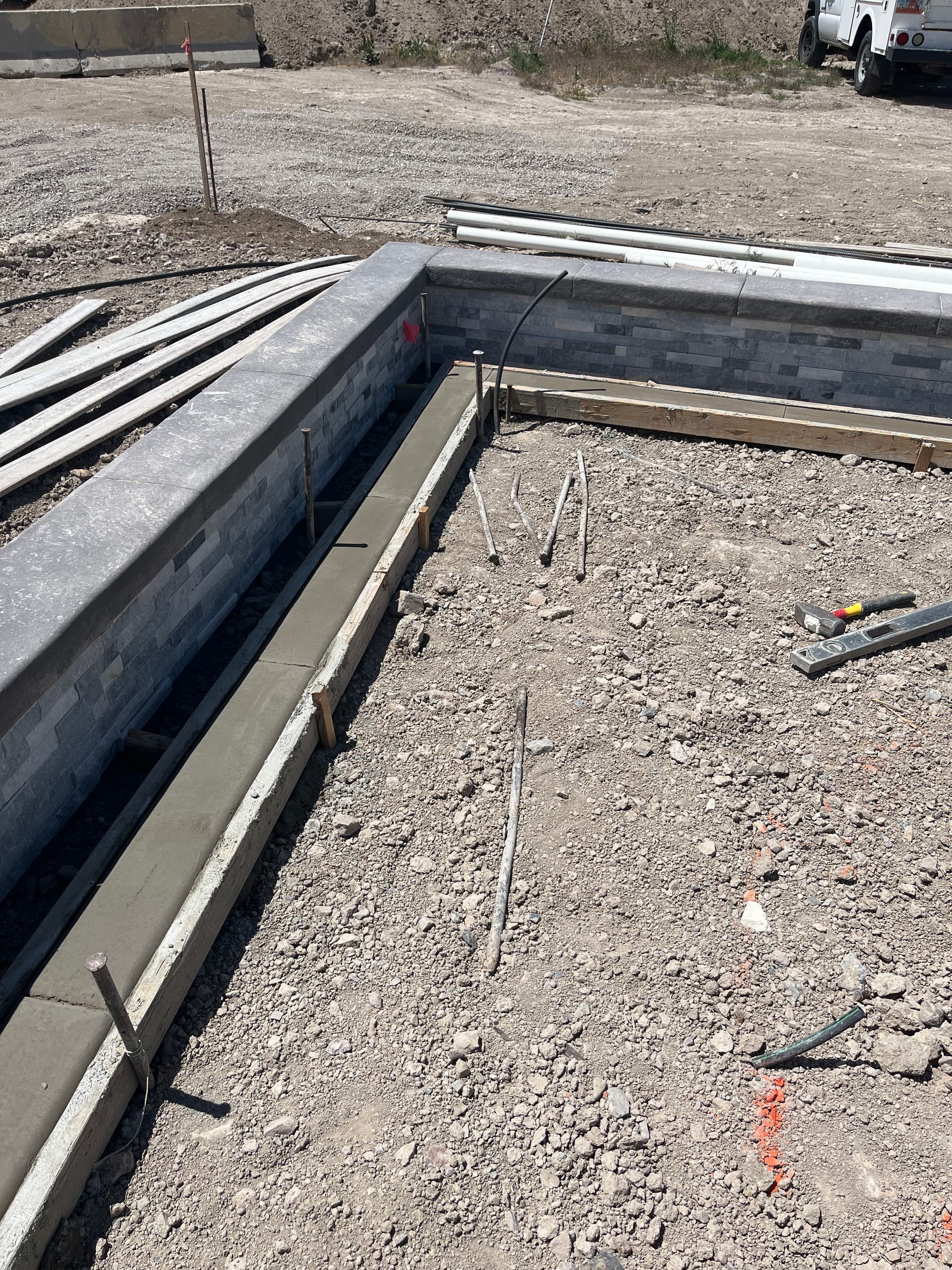 Gallery photos for Concrete Curbing Ties Pool Decking Into Stone Retaining Wall: Image #1