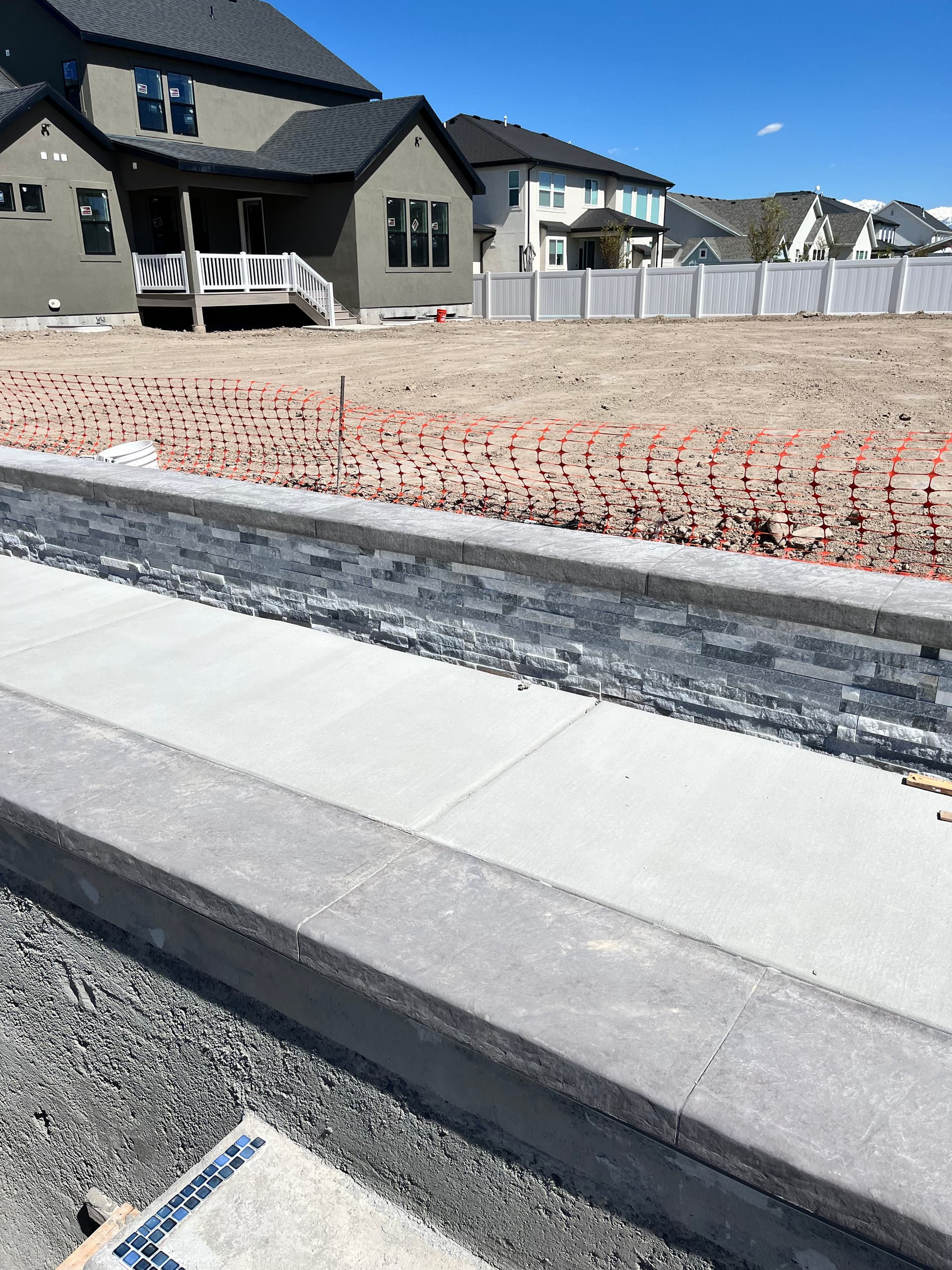 Gallery photos for Custom Retaining Wall with Stone Veneer and Stamped Concrete Cap: Image #2