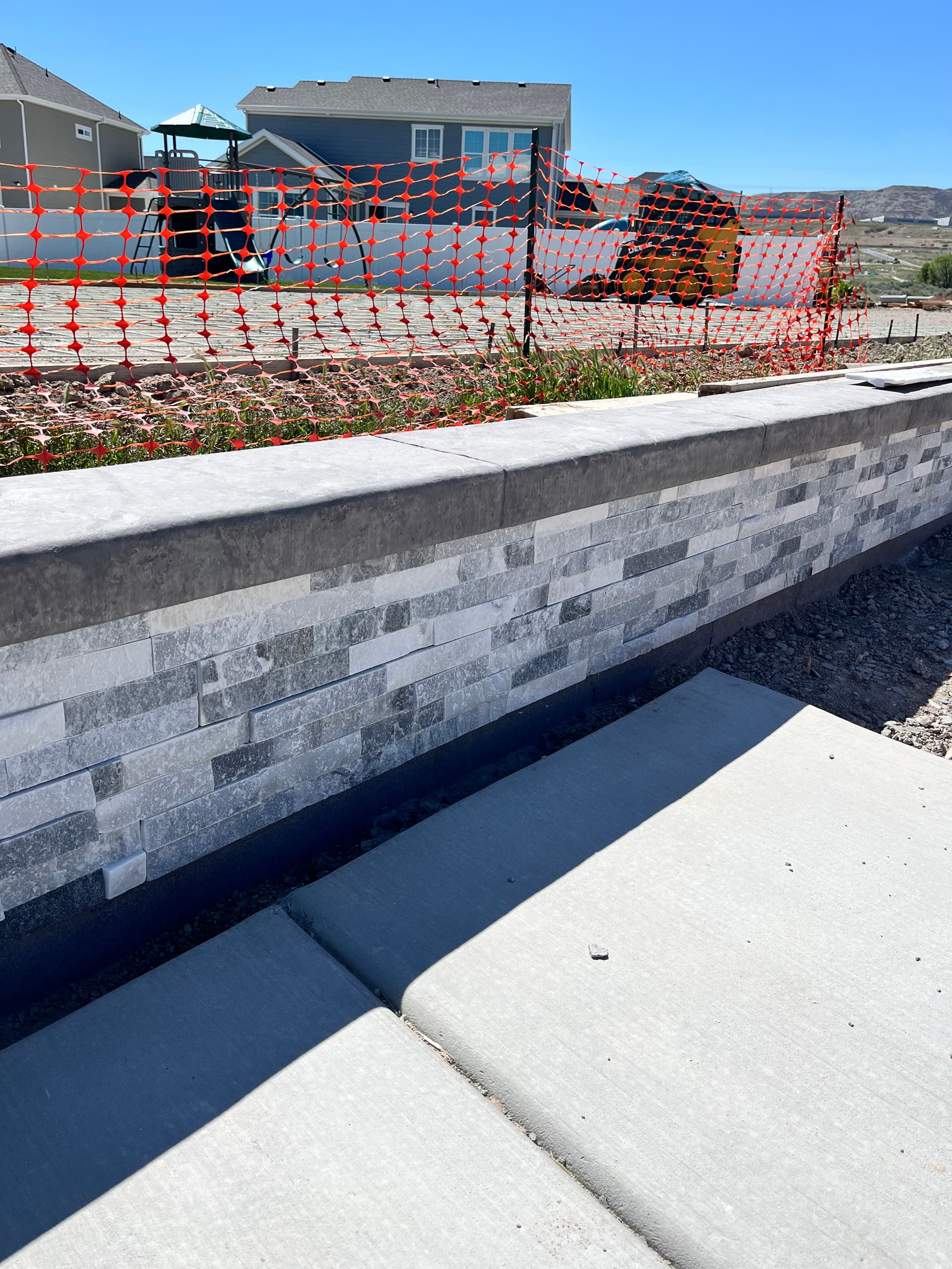 Gallery photos for Custom Retaining Wall with Stone Veneer and Stamped Concrete Cap: Image #1