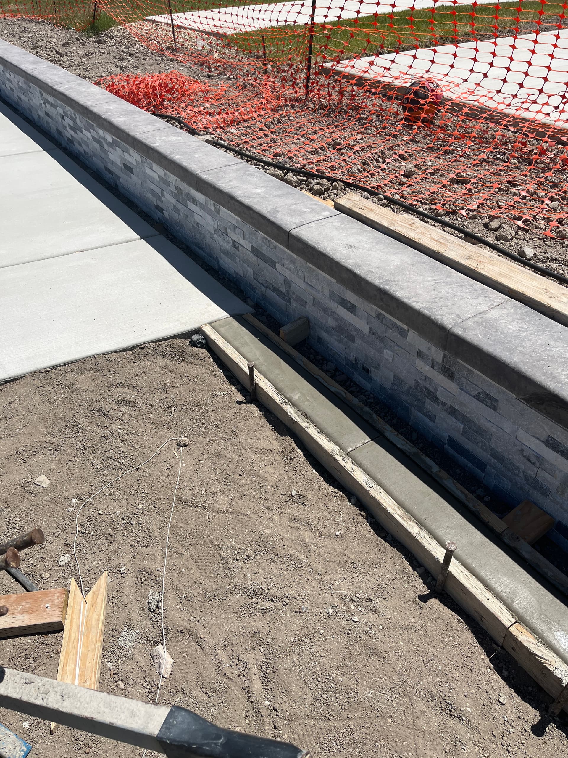 Gallery photos for Concrete Curbing Ties Pool Decking Into Stone Retaining Wall: Image #2