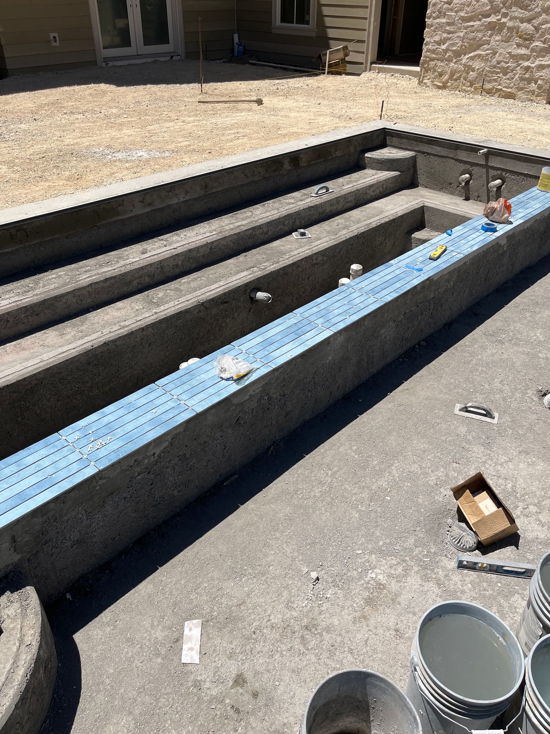 Setting 2x18 Tile on a 50-Foot Custom Pool Build image